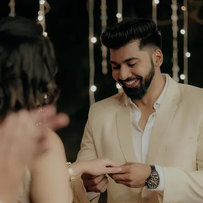 The exact moment he places the ring on her finger, a priceless memory captured forever during their engagement ceremony.