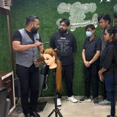 Education is everything. Here, our National Technical Head, Mr. Mahesh Gore, teaches a group of stylists the science behind a haircut using a mannequin head. We start with strong fundamentals.