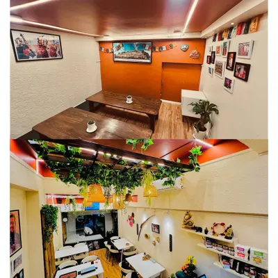 Our restaurant offers different seating areas to suit your mood. The top image shows our cozy upper deck with traditional low tables for a more grounded dining experience, while the bottom view captures the vibrant main dining area, filled with greenery and warm light.