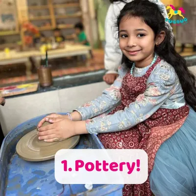 A young artist finds her focus at the pottery wheel. This activity is wonderful for building concentration and patience, as children learn to shape the clay with gentle, steady hands.