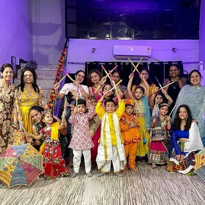 Our Dandiya Nights are where tradition meets celebration. This group photo captures the joy of our members, both adults and kids, dressed in colorful traditional attire, ready to dance with dandiya sticks.