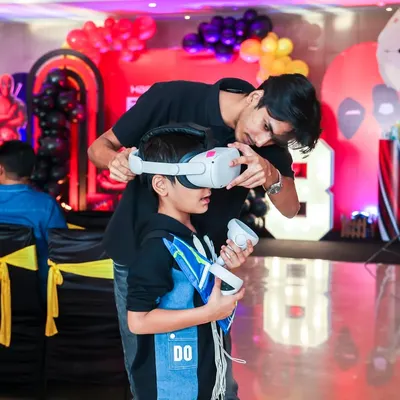 A guest being fitted with a VR headset by our staff member, ensuring a comfortable and safe entry into the world of virtual reality gaming.