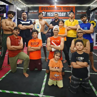 Attitude is in our blood. The team posing at our gym in Tagore Garden, with fighters of all ages, including a Super Fight League champion.