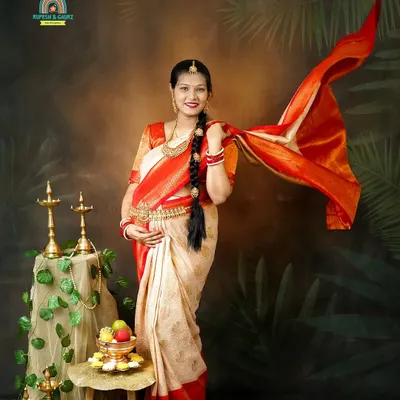 A beautiful portrait of the mom-to-be in a traditional South Indian silk saree. The flowing pallu adds a dynamic and graceful element to this culturally rich maternity photo.