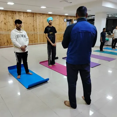 Our coach leading a yoga and stretching session for our shooters. These exercises are crucial for developing the mental and physical fortitude required in competitive shooting.