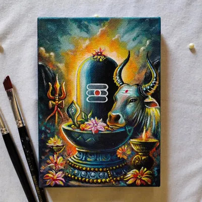 The finished Mahadev painting, resting next to the brushes I used to create it. This piece is filled with vibrant colors and spiritual details.
