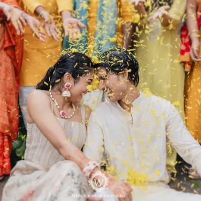 A moment of pure joy and laughter during a Haldi ceremony. We created a backdrop of vibrant yellow florals and rustic cane baskets to create a space that felt like basking in sunshine.