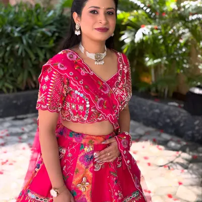 A full-length view of the soft glam look, showing how the makeup complements the vibrant pink floral lehenga, making it perfect for a day wedding or party.
