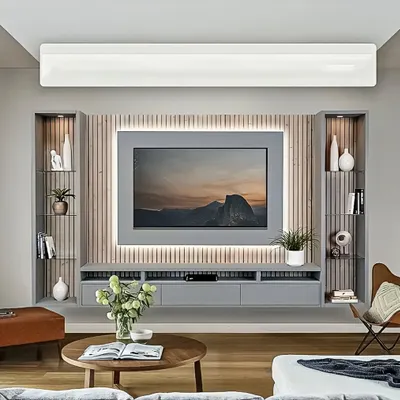 A sleek, floating entertainment unit in a calming grey finish. The design features a fluted wood panel backdrop with integrated LED lighting, creating a sophisticated and modern focal point for the living room.