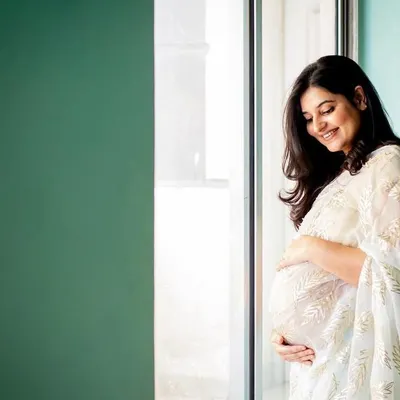 I love how the soft window light illuminates this mama-to-be. Dressed in a beautiful white sari, this solo maternity portrait is the definition of grace and elegance.