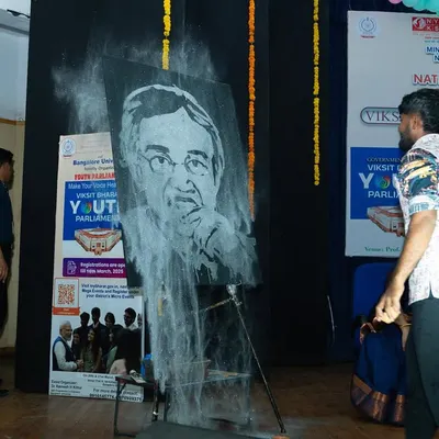 A moment during my speed painting performance at Bangalore University. I'm using quick, broad strokes to build the foundation of the portrait before the final details are added.