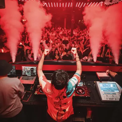 This is what it looks like from my perspective at a packed club in Goa. The energy is electric, with smoke cannons firing over the crowd.