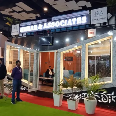 Our exhibition stall at the Darc Build expo, featuring a fully realized container unit. The prominent "Kumar & Associates" branding sits atop the structure, which showcases our capabilities in creating stylish and modern container homes, offices, and cafes.
