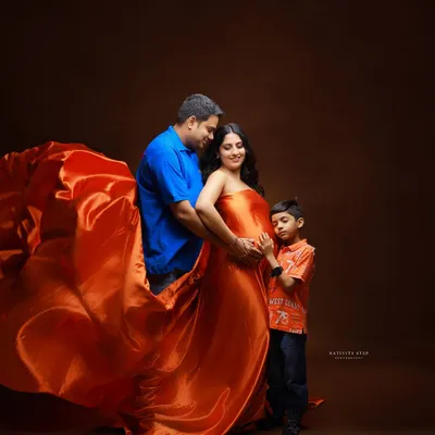 A beautiful family portrait, including the older sibling. It's so special to capture the excitement of a big brother or sister as they wait for the new baby.