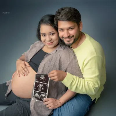 Including your sonogram pictures is a wonderful way to make the shoot even more personal. This pose shows the couple proudly displaying the first pictures of their baby.