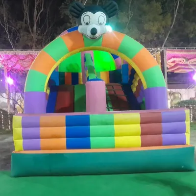 A classic Mickey Mouse themed bouncy castle, perfect for a child's birthday party. This inflatable includes a small slide and jumping area, ensuring hours of fun in a compact space.