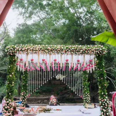 A breathtaking floral mandap at our Pond Pavilion, with cascading flower strings creating a dreamy backdrop for the wedding ceremony.