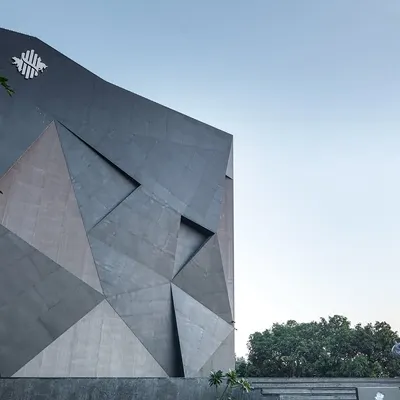 The facade of the Aventador Office in Hoshiarpur was inspired by the sharp facets of a rare black diamond. This design choice gives the building a bold, sculptural presence that makes a strong statement from the moment it is seen.