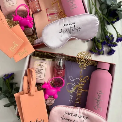 A beautiful bridesmaid hamper filled with personalised travel essentials. This set includes custom luggage tags, a water bottle, a scented candle, and a pretty eye mask, perfect for a destination wedding.