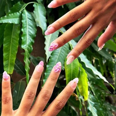 Perfect for summer, this set features beautiful 3D sculpted pink flowers on long, almond-shaped extensions. The design is complemented by a pink plaid pattern and gold bead accents.