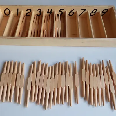 This is the Spindle Box, a key Montessori math material. It helps children connect a numeral with its actual quantity. The empty "0" compartment is a powerful, concrete introduction to the concept of zero.