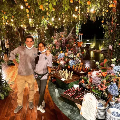 Here we are with our setup for a Tuscan-themed party. The decor was as stunning as the food, with a beautiful spread of desserts and canapés set against a backdrop of lush florals and hanging lights.