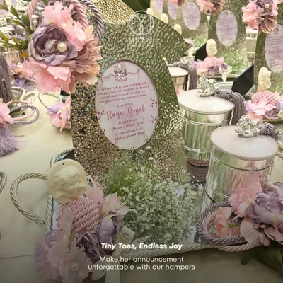 "Tiny Toes, Endless Joy." Our baby announcement hampers are designed to make the announcement unforgettable. This one features a silver-plated tray, a hammered photo frame, and keepsake jars in a lovely lavender and silver theme.