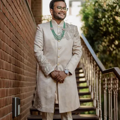 A portrait of the groom in his elegant sherwani, looking sharp and ready for the big day. We make sure the groom's style is captured with sophistication.