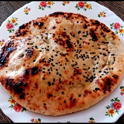A fluffy, perfectly charred millet naan stuffed with savory tofu. Learning to make gluten-free breads that are soft and delicious is one of the most rewarding skills I teach.