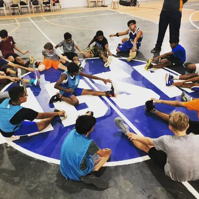 Cooling down together after a tough practice. The work is important, but so are the moments we share as a team, stretching and talking on our home court.