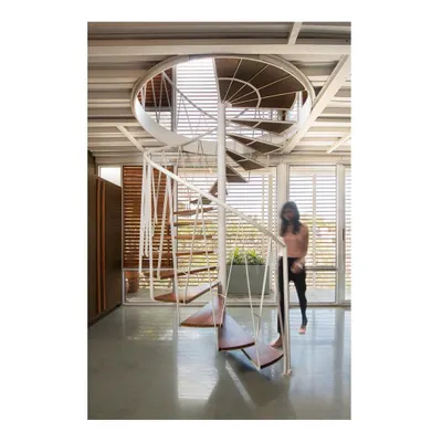 A spiral staircase designed for our own studio, connecting the main workspace to an interaction area above. The structure is composed of a "woven" steel support system and treads made from recycled teak wood, creating a functional sculpture.