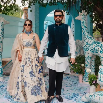 A couture-inspired Mehendi where the decor is as stylish as the couple. The backdrop features custom animal sculptures painted with blue Dior-esque patterns, creating a whimsical yet high-fashion photo opportunity.