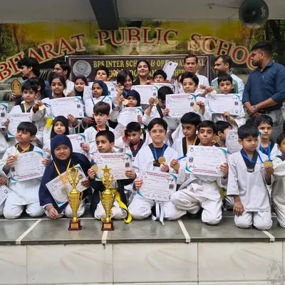 Our team of champions from Strike International Taekwondo Academy posing with their well-earned trophies and certificates after a successful tournament.