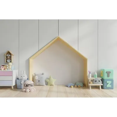 A minimalist and playful corner in a child's room. The house-shaped nook provides a perfect spot for reading and imaginative play, designed with safety and fun in mind.