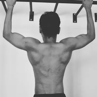 This shot highlights the result of consistent bodyweight training. Developing the lats, traps, and rhomboids through exercises like pull-ups is essential for a healthy spine and powerful upper body, which I emphasize in my conditioning programs.