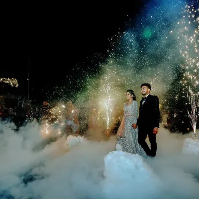 A grand entrance for the couple at their reception, walking through a cloud of low fog and sparkling pyrotechnics. This is how we create magical, cinematic moments.