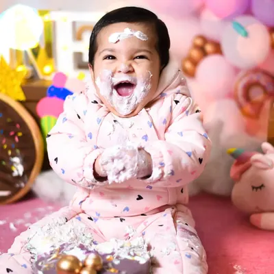 The perfect shot of pure, messy happiness. This is from Prisha's first birthday cake smash, where she couldn't stop laughing while covered in frosting.