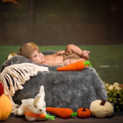 My crochet carrot and pumpkin amigurumi toys being used as props in a professional photoshoot. They add a touch of handmade charm and texture to the scene.