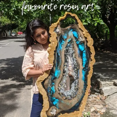 Holding one of my favorite custom geode resin creations. The combination of brilliant blue, earthy tones, and sparkling crystals makes this a true statement piece.