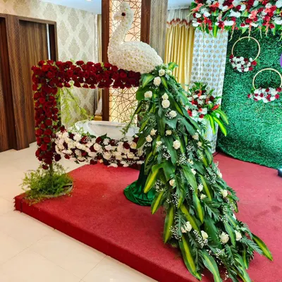 Welcoming a new life is a precious occasion. For this naming ceremony, I sculpted an elegant peacock from fresh flowers and foliage, with its cascading tail gracefully draping over the baby's cradle. It’s a bespoke piece that adds a touch of artistry to the celebration.
