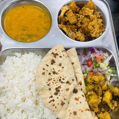 Our standard roti and rice meal. This thali comes with soft rotis, steamed rice, flavorful dal, aloo gobi sabzi, and a side of our special fried snack and fresh salad.