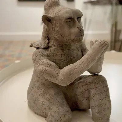 The Hanuman sculpture, after the initial sculpting and detailing. Here you can see the intricate calligraphy work I carved into the clay body before firing. This piece was a long journey of patience and shifting ideas.