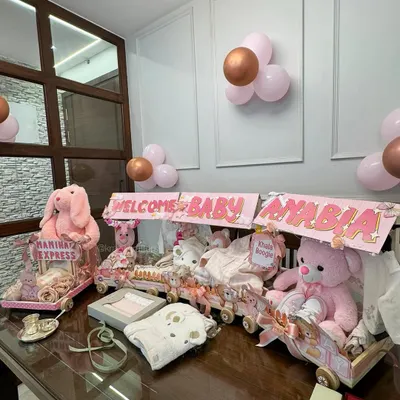 A full view of the 'Nanihaal Express', a custom baby trousseau train I designed to welcome a newborn girl. Each carriage is filled with gifts, clothes, and toys, creating an unforgettable welcome home display.