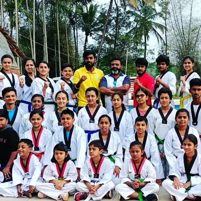 Our team of dedicated students and coaches during a break at our Madikeri Taekwondo camp. We believe in training hard and building a strong community outside the dojang.