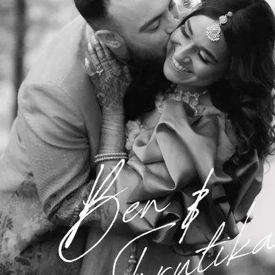 A classic, timeless black and white portrait. The focus is entirely on their emotional connection, his gentle kiss and her radiant smile. This is the kind of image that never goes out of style.