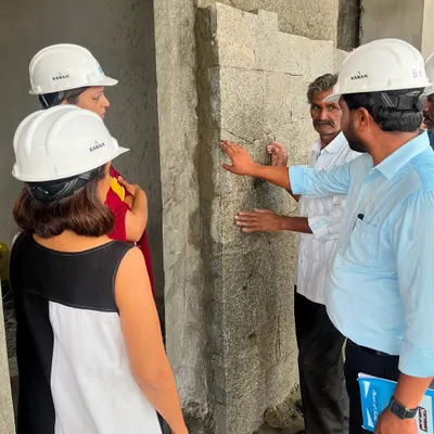 Our process is an orchestra of decisions. Here, our team is on-site, discussing the texture and finish of a stone wall with the masons, ensuring every detail aligns with our design intent.
