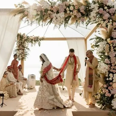A beautiful boho-chic mandap for a sun-drenched outdoor wedding, featuring pampas grass and pastel roses.