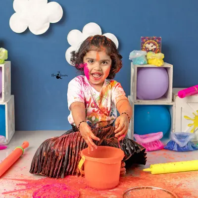 Pure messy joy during our Holi mini-session. This little girl is having a blast playing with safe, organic colors in our specially designed studio set.
