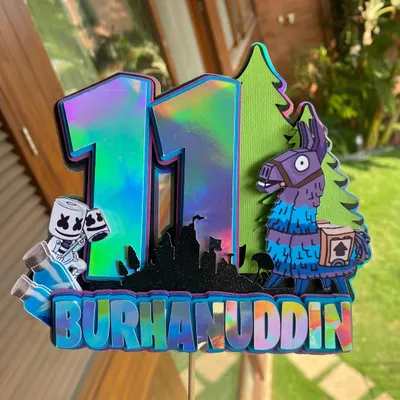 A close-up of our holographic Fortnite cake topper. This piece is perfect for gamers, featuring the iconic llama and other game elements in a cool, iridescent finish.