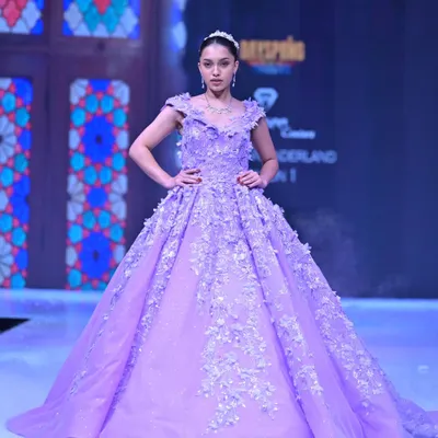 A closer look at the lavender ball gown from my GULFAM collection, showcasing the handcrafted 3D floral appliqués against a backdrop of intricate patterns. This is couture craftsmanship you can see and feel.